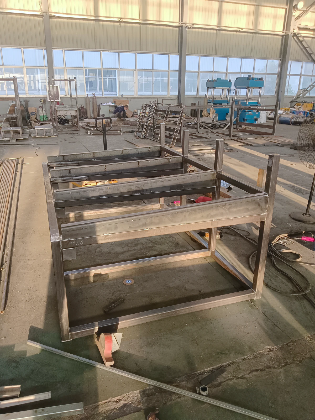 Welded rectangular metal frames showing fabrication joints and surface marks